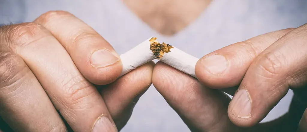 hands breaking a cigarette for stop smoking and becoming a non-smoker